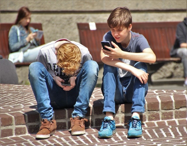 kids playing on their smartphones 