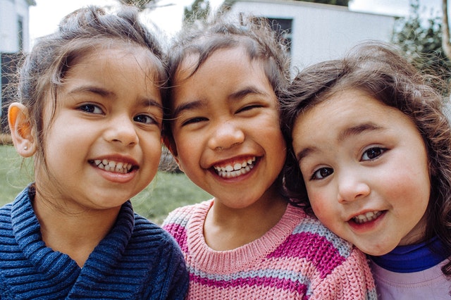 three smiling kids