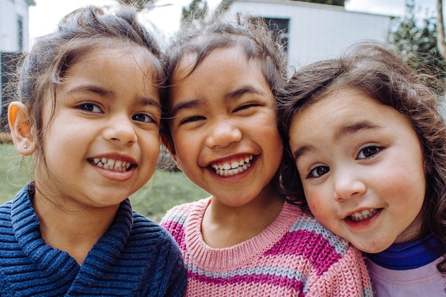 three smiling kids 