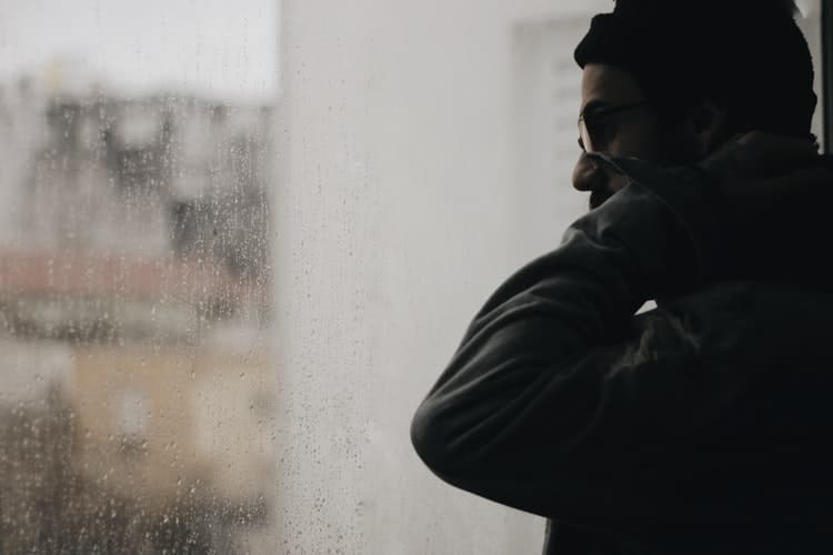 Man looking out a window.