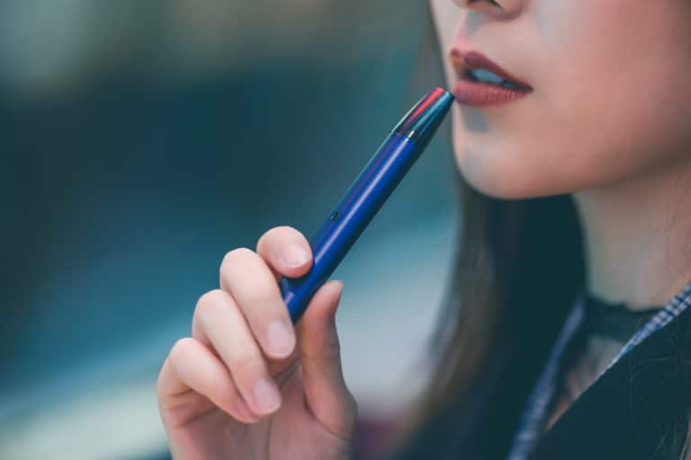 woman holding a vape pen