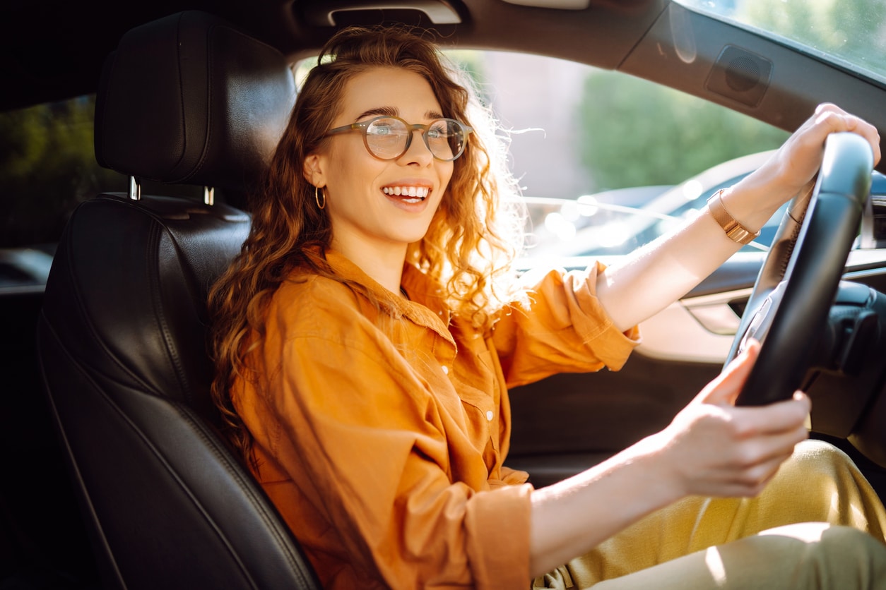 Happy woman driving.