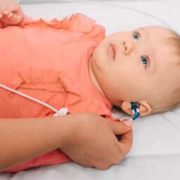 Baby girl having her hearing tested